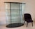 Rare and highly sought-after FIAM Italia Ellisse 55.5” wide two-door curved glass display cabinet, designed by Vittorio...