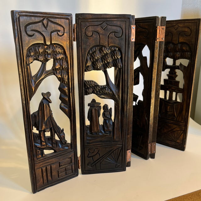 This six panel wooden folding screen is hand carved with Asian designs. Each panel features a different scene. Small...
