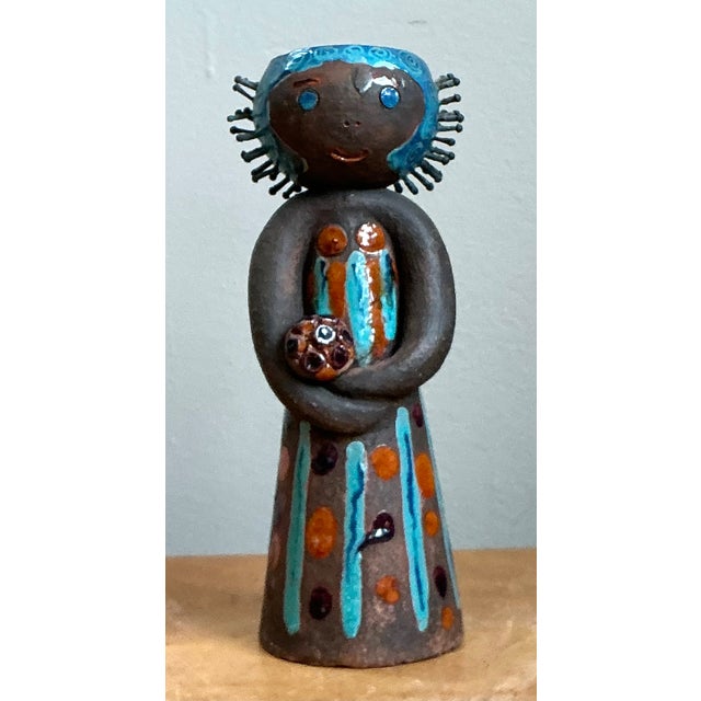 This vintage hand-painted ceramic figurine candlestick is a charming example of mid-century decorative folk art, blending...
