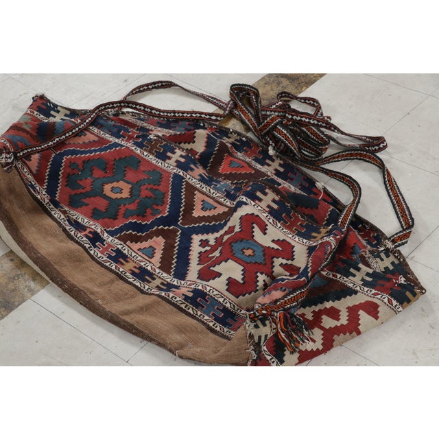 Handwoven in wool circa 1920-1930, this 3x5 Kilim is an antique Russian bag—a collectible textile once used by nomadic...