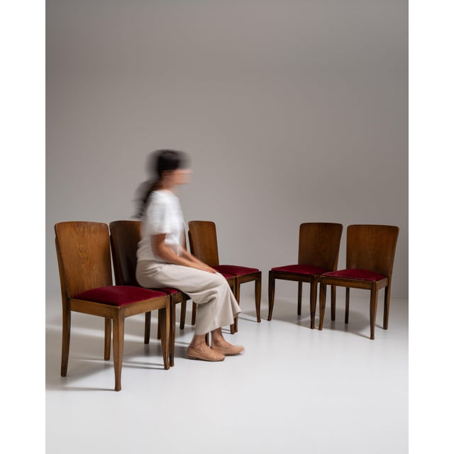 This set of six 1940s Art Deco dining chairs from Czech Republic, made in curved honey-toned wood with burgundy seats. The...