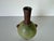 This charming vintage pottery vase is a testament to artisan craftsmanship. Its unique spherical body features a soft...