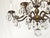 This Antique 8 Arm Sensational Dark Patina Brass Cut Lead Glass Crystal Chandelier from the 1950s exudes elegance and...