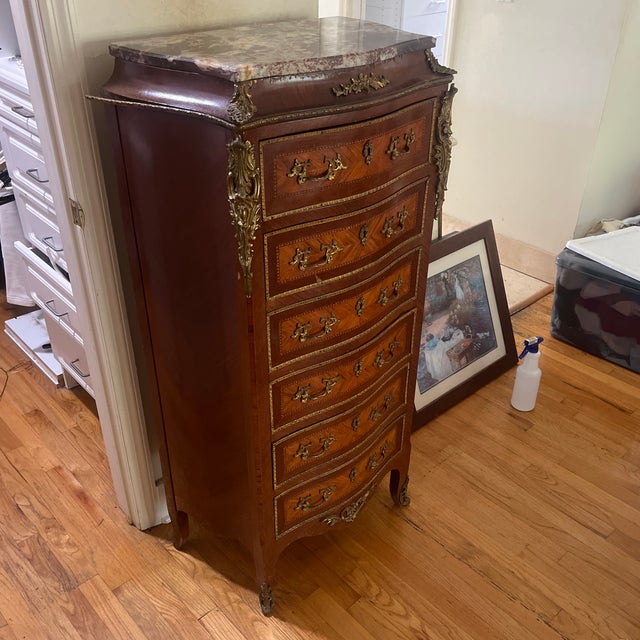 Louis XV style antique chiffonier, with intricate brass detailing and chestnut wood. Includes 6 drawers that work well.