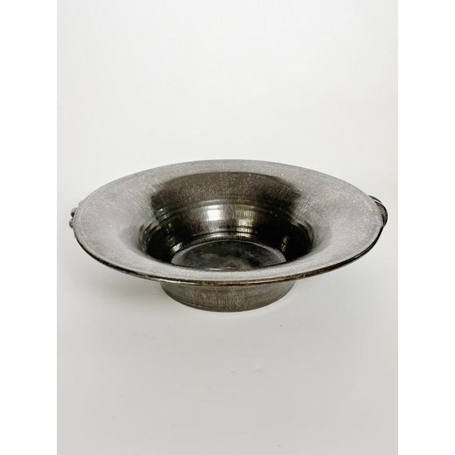 Elegant French ceramic fruit basket dating from the 1970s, distinguished by its beautiful iridescent metallic glaze that...