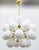 Italian sputnik chandelier with 24 matte white Murano glass globes mounted on brass frame in unlacquered natural brass...