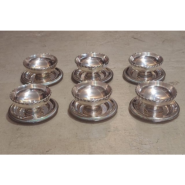 Purchased in France, this elegant vintage silver-plated dessert service includes six pedestal dessert bowls and a matching...