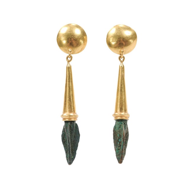 A spectacular pair of earrings made with 21 karat gold and small bronze arrow heads with a deep patina of verdigris - a...