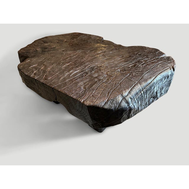 Impressive six inch single slab coffee table made from century year old teak wood. We added four thick block legs and...