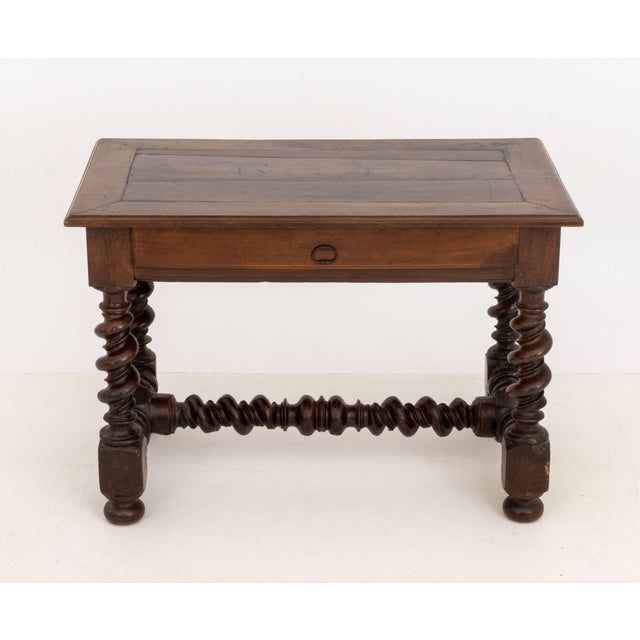 Louis XIII Walnut Table, the rectangular top with single drawer above barley twist turned wood legs conjoined by H-form...