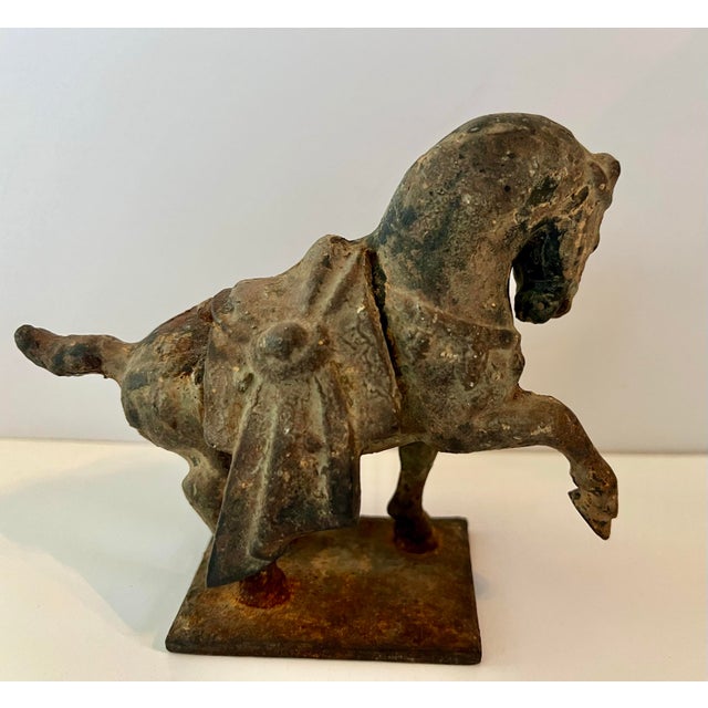 Vintage cast iron Chinese Tang Dynasty horse sculpture. The cast iron sculpture of a horse is patinated and aged. Mounted...
