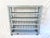 This gray painted wood bakery cart was sourced in France. The history of this boulangerie rack cart is seen in its...