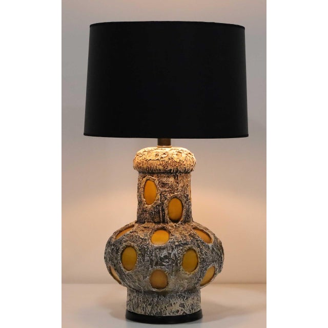 These are so unique and great looking. Heavy textured ceramic ornamented with glazed ceramic carve outs make these lamps...