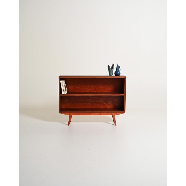 Mahogany bookcase with two open compartments and tapered legs. Scandinavian production, 1960s. The simple construction...