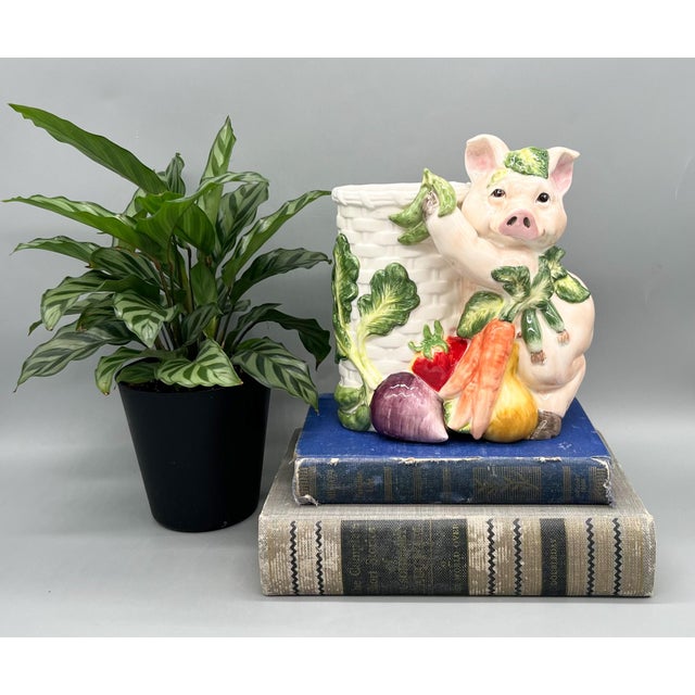 Charming and whimsical pig utensil holder. Incredible details and vegetable accents make this an eye-catching piece....
