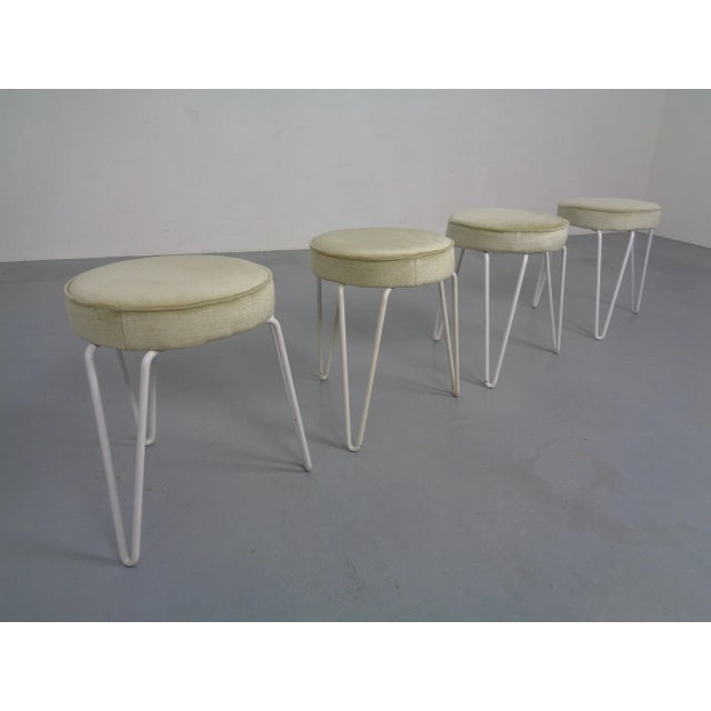 Set of 4 hairpin stools from the 1960s. The legs are made of white painted metal and were probably repainted before. Seats...