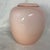 This is a vintage Larry Laslo for Mikasa pink cased art glass vase featuring a smooth, glossy opalescent finish and a...