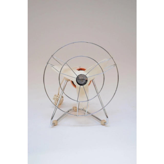 Small Italian modernist fan in pink and cream with adjustable metal base (ca. 1960s, Italy). There are rubber 'foot'...