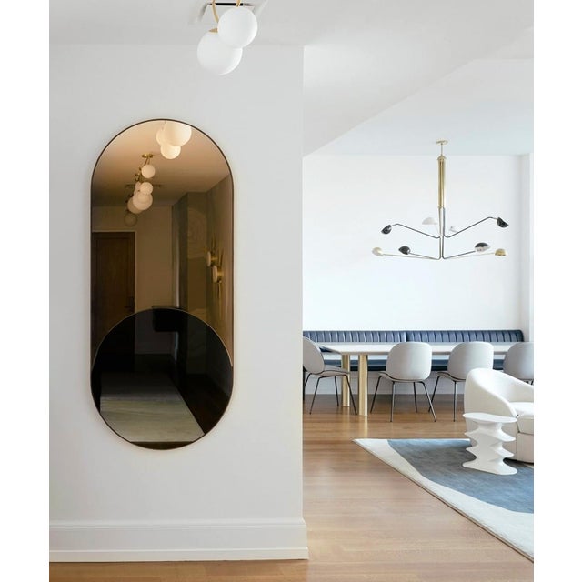 Materials: Black and Gold mirror, steam bent walnut frame Dimensions: 20-1/2 x 36-1/2 x 1 in Weight: 23 lb Note: Mounting...