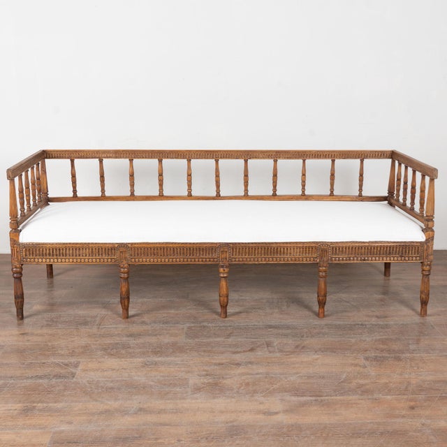 19th century Swedish carved Gustavian bench or settee, crafted in dark pine. Beautiful carved details are the highlight of...