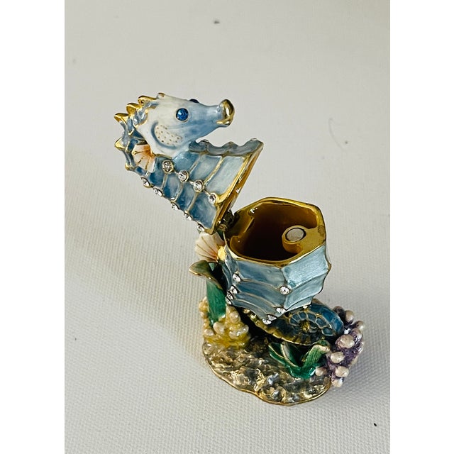 Gorgeous polychrome enamel on brass Sea horse figurine that opens into.a box and closes on metal magnet. Embelished with...
