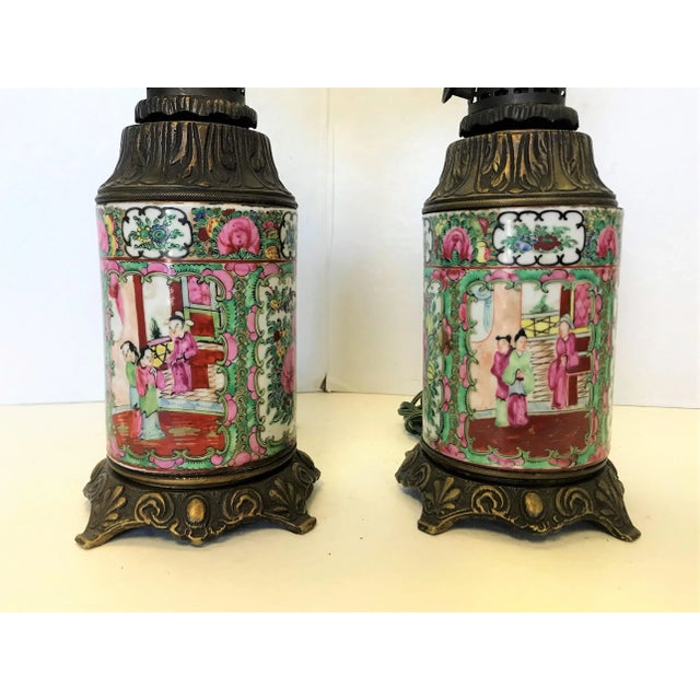 Superb pair of antique lamps in the chinoiserie style. These antique porcelain and bronze oil lamps have been converted to...