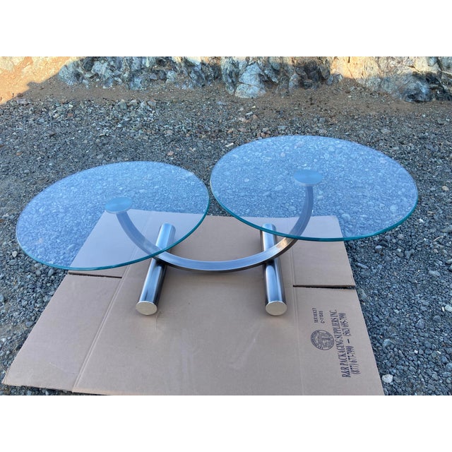 Vintage mid century Post Modern Tubular Steel & Beveled Glass Two Tier Coffee Table is a stylish and unique piece of...