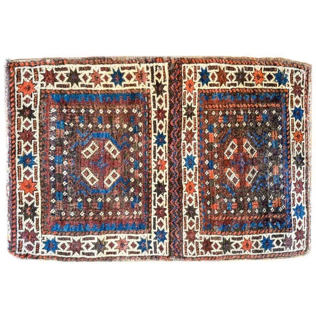 A beautiful early 20th century Persian Turkmen rug composed with two squares each with its own medallion amidst fields of...