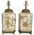 Offering a pair of vintage Chinese porcelain table lamps with flowers and leaves with gold detailing, circa Late 20th...