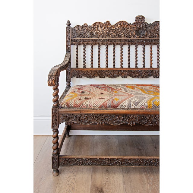 Richly carved and exceptionally detailed, this late 19th-century Jacobean Revival hall bench showcases the remarkable...