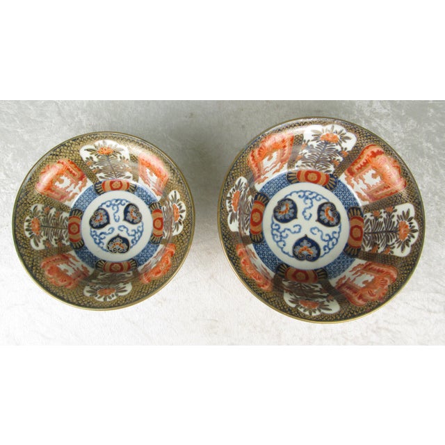 Set of 2 Antique 19th Century Japanese Arita Imari Porcelain bowls in white, red, blue and gold. The bowls have geometric...