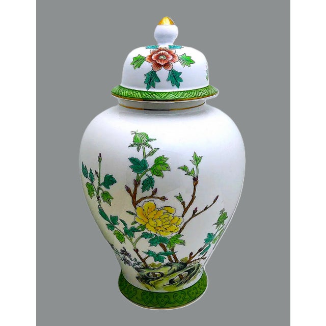 Striking Andrea by Sadek porcelain lidded jar featuring vibrant hand-painted emerald green and florals in yellow, pink,...