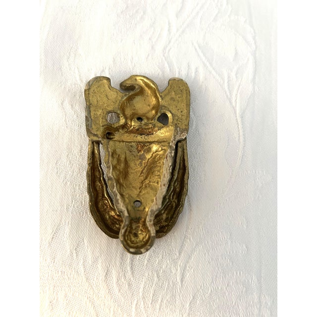 Mid-century solid, polished brass, door knocker featuring an American Eagle. Holes in place for mounting.