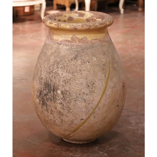 This impressive antique earthenware olive oil jar was crafted in Biot, Provence, Southern France, circa 1760, and...
