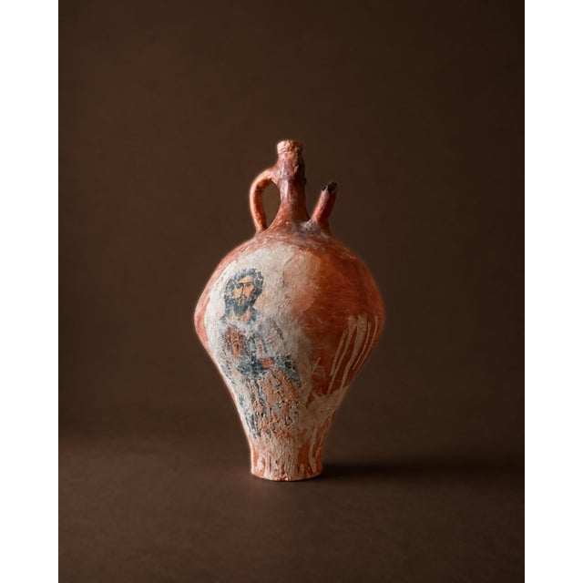 A sculptural amphora shaped with a restrained, classical profile and finished with a surface that reads as quietly...