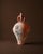 A sculptural amphora shaped with a restrained, classical profile and finished with a surface that reads as quietly...