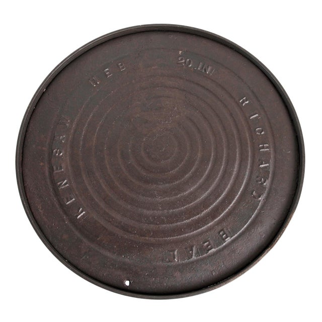 Striking industrial side table is crafted from an authentic vintage iron manhole cover, repurposed into a sculptural and...