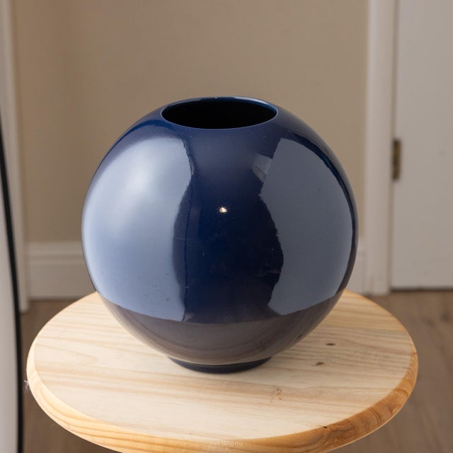 Large vintage ceramic sphere vase with a sculptural orb form and deep glossy navy blue glaze. The nearly spherical body...