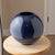 Large vintage ceramic sphere vase with a sculptural orb form and deep glossy navy blue glaze. The nearly spherical body...