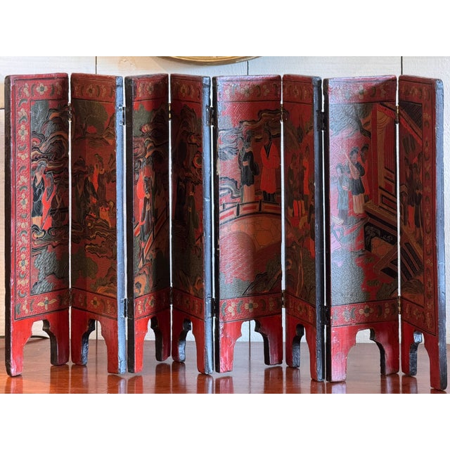 Folding tabletop screen labeled “Chinese Table Screen,” formed of multiple narrow hinged panels arranged in a continuous...