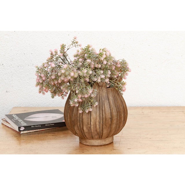 Ten overlapping petals rise from a rounded base to form this bowl's silhouette, each one hand-carved with a deep central...