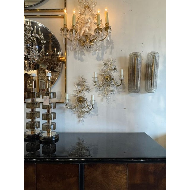 This product is a pair of vintage Italian sconces with a Bagues manner style design. These elegant fixtures would be a...