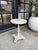 Vintage side table with a round marble top and painted pedestal base. Compact scale suitable for use as a side table,...