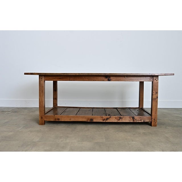 An English farmhouse work table/drapery table from the 19th century, recently shortened for use as a coffee table to bring...