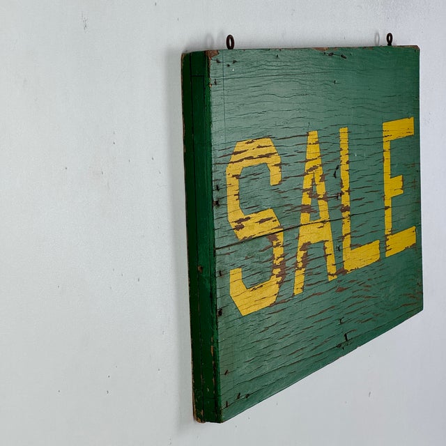 A beautiful aged SALE sign on wood with bright green and yellow. Its simplicity is its beauty. Two original hooks still...