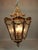 A refined circa 1970 French Louis XVI–style lantern chandelier, crafted from bronze with a warm gold patina and clear...