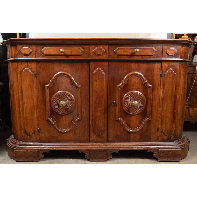 Stately, two-over-two, 1850s, hand carved, rounded edge, solid walnut buffet on a raised, stepped base of the same. The...
