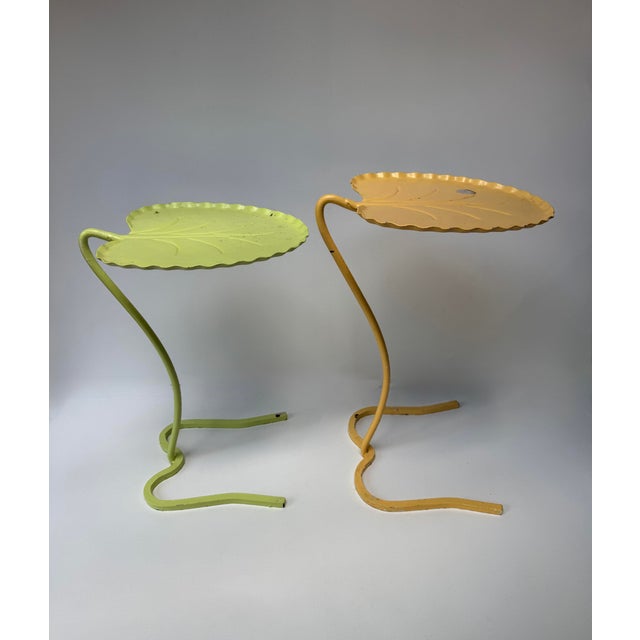 Pair of vintage wrought iron lily pad tables attributed to John Salterini. Each has a leaf-form metal top with scalloped...