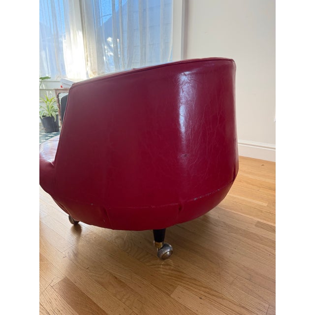 Rescued from a Miami hotel lobby, this swivel chair was recovered in red faux leather a few years back. 34” w x 25” d x...