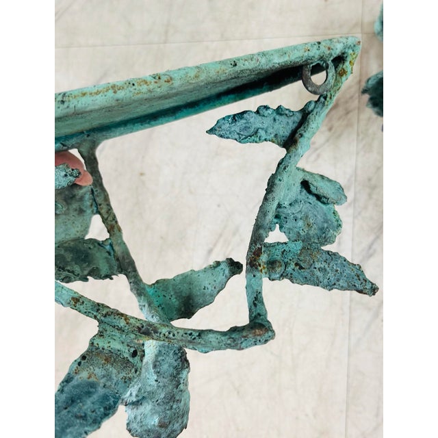A striking pair of hand-sculpted bronze wall shelves, organically formed with the raw elegance of botanical growth . Each...